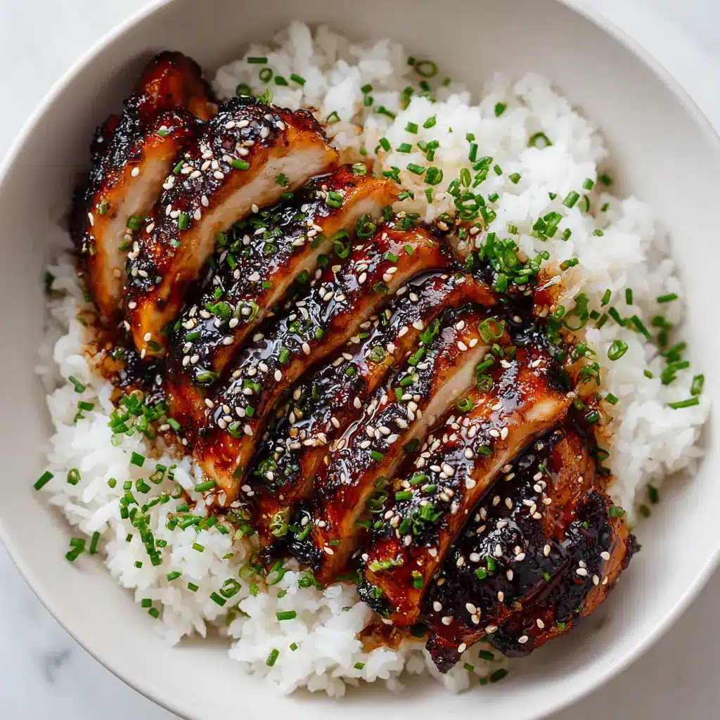 Grilled teriyaki chicken being glazed with a thick sauce while on the grill. The flames in the background create a dynamic and appetizing action shot for this Japanese-inspired recipe.