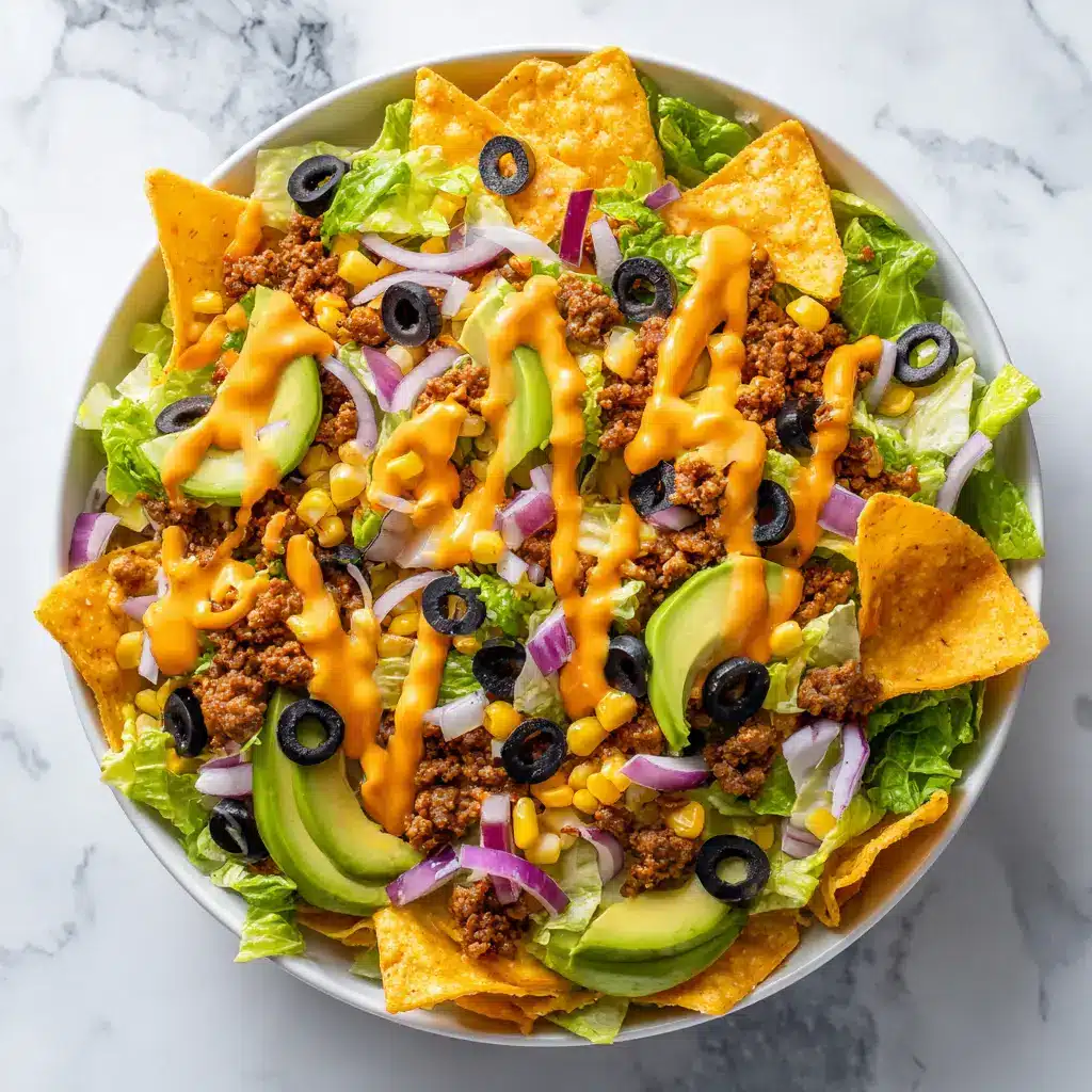 Doritos Taco Salad Recipe: The Ultimate Crowd-Pleaser 1 A serving of the layered Doritos salad on a white plate, showing the textures of the crunchy chips and the seasoned meat.
