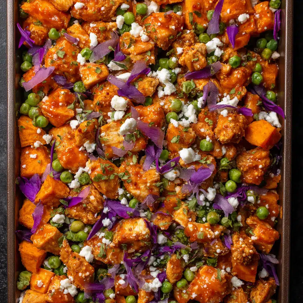 Crispy baked breaded chicken coated in a glossy orange buffalo sauce next to roasted sweet potatoes.